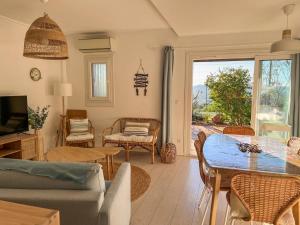a living room with a couch and a table at Le Mazet au Lavandou in Le Lavandou