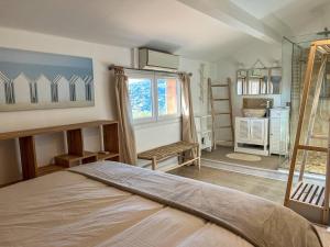a bedroom with a bed and a window at Le Mazet au Lavandou in Le Lavandou +17 photos