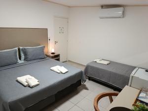 a bedroom with two beds with towels on them at My Place Boutique Hotel in Puerto Iguazú