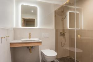 a bathroom with a toilet and a sink and a shower at Comfort Hotel Park in Trondheim +104 photos