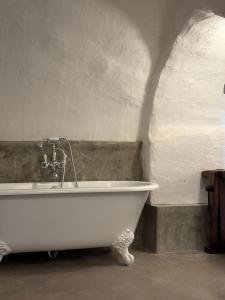 a white bath tub in a room with a wall at L'Hostal de Piaghja in Calenzana +15 photos