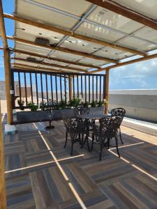 a patio with a table and chairs on a roof at Apartamento Edifíco Prestige in Marechal Deodoro