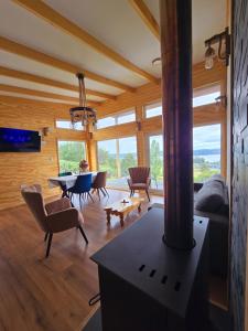 a living room with a fireplace and a table and chairs at Casa Río de Mozzi in Castro