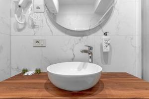 a bathroom with a white bowl sink and a mirror at Welcome Foresteria Lombarda in Milan +16 photos