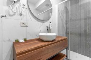 a bathroom with a white sink and a mirror at Welcome Foresteria Lombarda in Milan