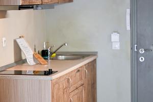 a kitchen with a sink and a counter top at Aggelos Grand in Koukounaries