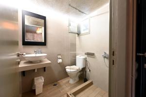a bathroom with a toilet and a sink at Aggelos Grand in Koukounaries