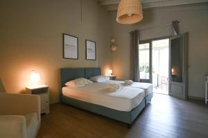 a bedroom with a bed and a sliding glass door at Aggelos Grand in Koukounaries