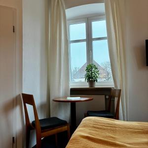 a room with a bed and a table and a window at Restaurant Rebea in Sulzburg +11 photos