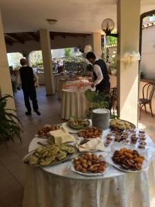 a table with plates of food on top of it at Belvedere Residence in Zungri
