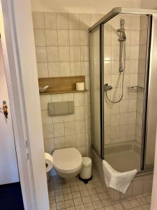 a small bathroom with a toilet and a shower at Restaurant Rebea in Sulzburg