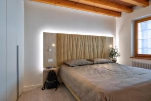 a bedroom with a large bed and a window at Domus Al Concilio in Trento