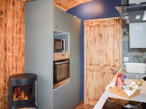 a living room with a fireplace and a stove at Badgers - Uk46750 in Herstmonceux