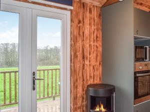 a fireplace in a kitchen with a balcony at Badgers - Uk46750 in Herstmonceux