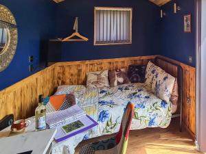 a small bed in a room with a table and a table sidx sidx at Badgers - Uk46750 in Herstmonceux
