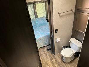 a small bathroom with a bed and a toilet at Big Pine Key RV Park in Big Pine Key +11 photos