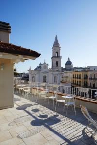 a balcony with tables and chairs on a building at GOLA Dimora storica in Cerignola