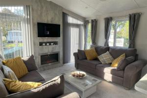 a living room with a couch and a fireplace at Poppy in Ferndown