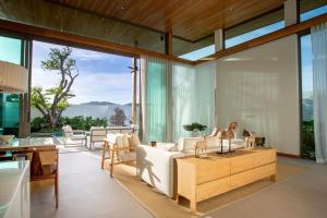 a living room with a couch and a table at OASIS Luxury Private Villa in Ban Phru Champa