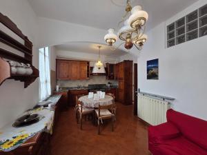 a kitchen and dining room with a table and a couch at Poesia - By Ligooria in Pietra Ligure