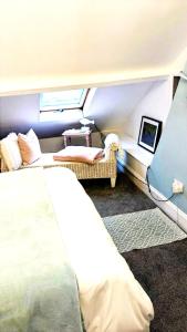 a bedroom with a bed and a couch and a window at The Bridges B&B in Broomhill