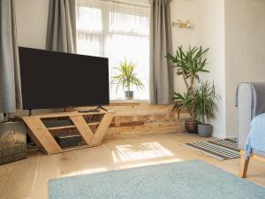 a living room with a flat screen tv on a wooden stand at Old Quay in Newlyn