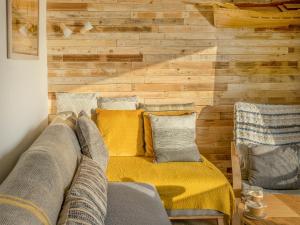 a living room with a couch and a wooden wall at Old Quay in Newlyn