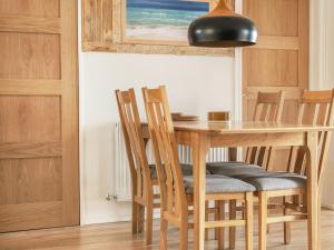 a dining room table with chairs and a black lamp at Old Quay in Newlyn