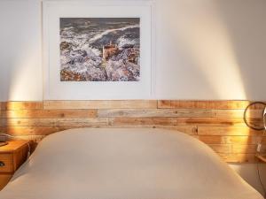 a bedroom with a bed with a picture on the wall at Old Quay in Newlyn +20 photos