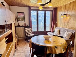 a kitchen and living room with a table and a couch at Les Marmottes 2 N 69 - 3P7 in Orcières +10 photos