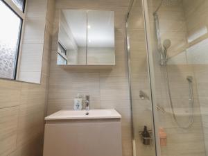 a bathroom with a sink and a shower at Wardenlea in Preston +18 photos