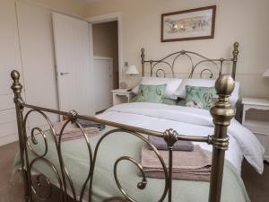 a bedroom with a bed with a metal frame at Wardenlea in Preston