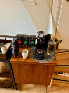 a coffee maker on top of a wooden table at Restaurant Rebea in Sulzburg