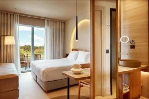 a hotel room with a bed and a balcony at Zeus Kos Beach in Mastihari