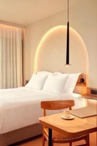 a bedroom with a bed and a table with a laptop at Zeus Kos Beach in Mastihari +81 photos
