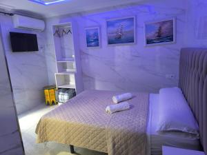 a bedroom with a bed with two rolled towels on it at Casa Salma in Seville