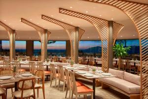 a restaurant with tables and chairs with a view at Zeus Kos Beach in Mastihari
