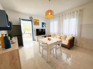 a living room with a white table and a couch at Villa Marzamemi in Marzamemi