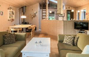 a living room with two couches and a table at Holiday Home Ingerslevvej Gørlev Vi in Gørlev