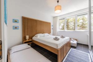 a bedroom with two beds and a window at Talea Joyful Stay by PikHost in Lezhë