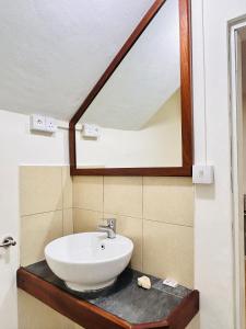 a bathroom with a sink and a mirror at Manuel's Apartment in Port Louis +9 photos
