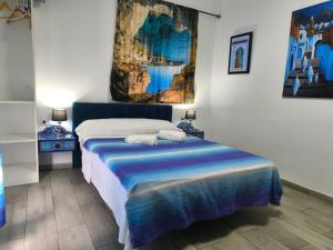 a bedroom with a bed with a painting on the wall at Casa Salma in Seville