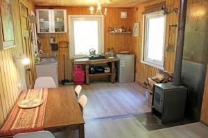 a kitchen with a table and a stove in a room at Cabaña Fio-Fio Conguillio National Park in Conguillío +31 photos