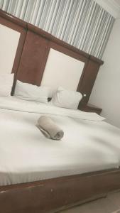 a bed with a wooden headboard and a hat on it at Sharm life 106 in Sharm El Sheikh