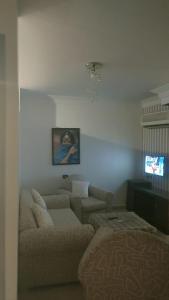 a living room with a couch and a tv at Sharm life 106 in Sharm El Sheikh