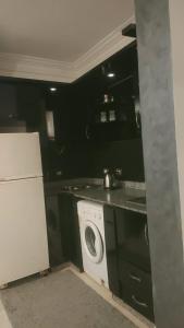 a kitchen with a washing machine and a washer at Sharm life 106 in Sharm El Sheikh +9 photos