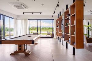 a billiard room with a pool table and shelves at House by Casa Septem in Tupungato