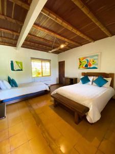 a bedroom with two beds in a room at FINCA HOTEL DON JULIO in Santa Rosa de Cabal