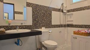 a bathroom with a toilet and a sink and a mirror at VK House Rawai, Phuket in Rawai Beach +33 photos