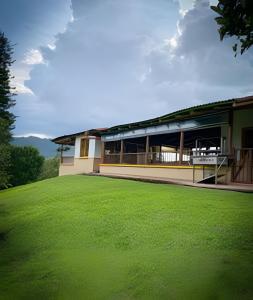 a building with a large lawn in front of it at FINCA HOTEL DON JULIO in Santa Rosa de Cabal
